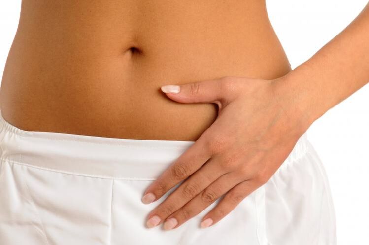 Pain in the lower abdomen as a symptom of cystitis in women